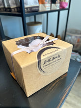Load image into Gallery viewer, 4 Pack of Comforting Calm Bath Bombs packaged in cardboard with a white ribbon tied around box.