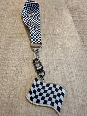 Checkered flag keychain on a checkered wrist lanyard attachment.  