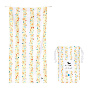 Kids quick dry towel that is yellow and white striped.  In the yellow stripes are pictures of rainbows, hearts, and sunshines.  