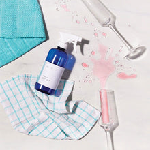 Load image into Gallery viewer, Capri blue multi surface cleaner laying by spilled liquid and a towel