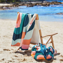 Load image into Gallery viewer, Quick Dry Towel in &quot;Get Wavy&quot; hanging on a beach chair. 
