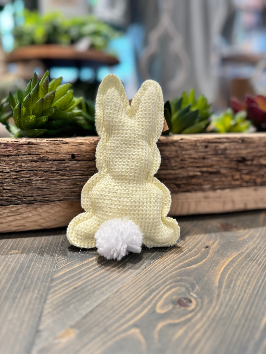 Adorable yellow stuffed bunny made with soft waffle-textured fabric, featuring a fluffy white pom-pom tail. Perfect for cuddling and playtime. (3.5