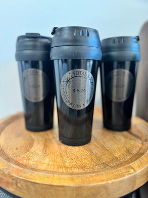 Black 16 oz travel mug with lid with a silver circle emblem in the center with black writing 