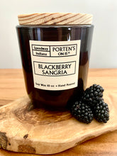 Load image into Gallery viewer, Blackberry Sangria 10 oz soy candle in a black jar with wooden lid.  
