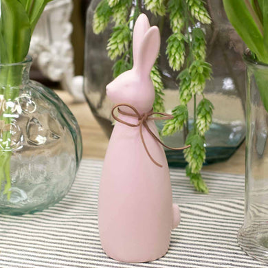 Light Pink Bunny Figurine with a leather bow around its neck. 