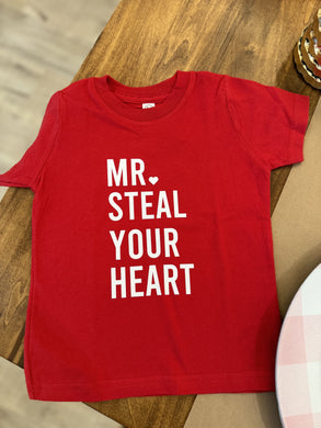 This playful kid's red tee features the phrase 
