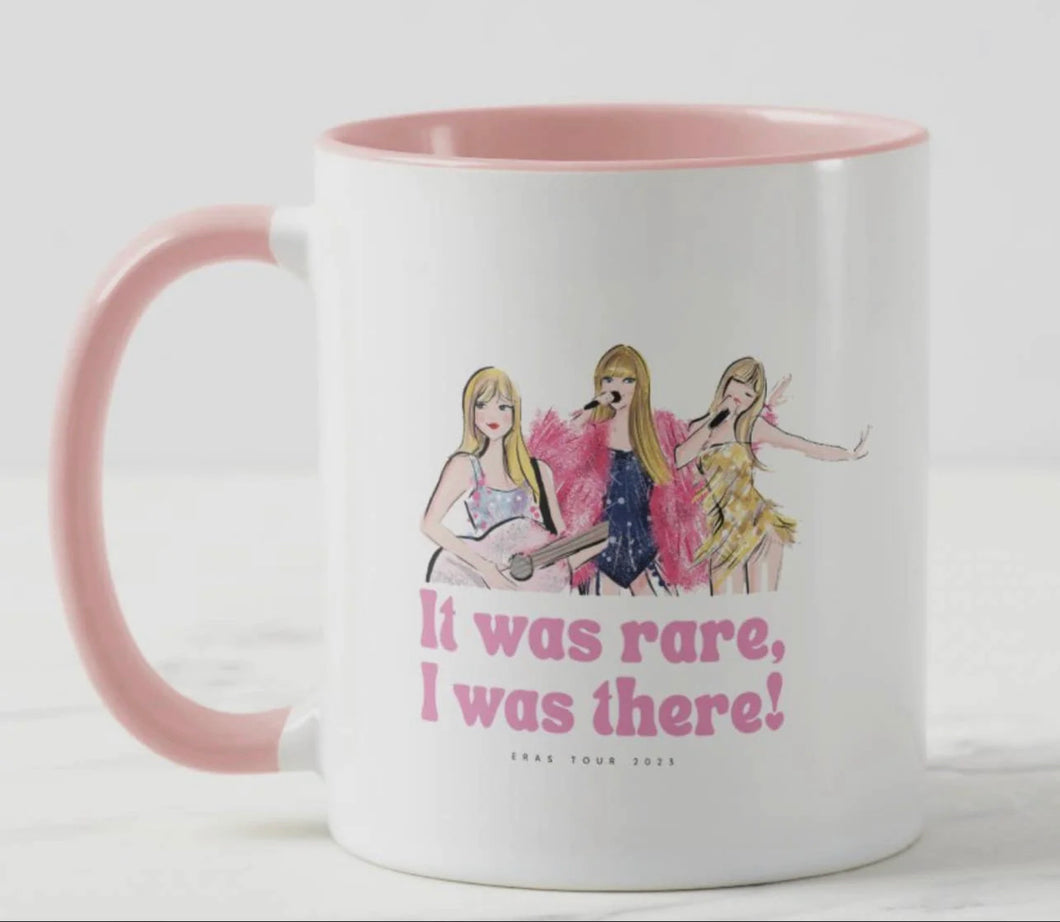 Taylor Swift Eras tour mug is white with pink inside and pink handle, picutres of Taylor on front with It was rare, I was there! Written on front