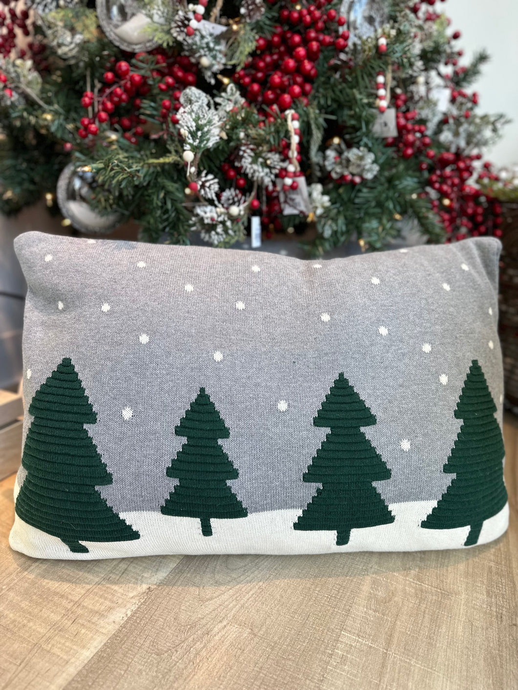 Grey Pillow with 4 dark green pines with a snowy scene backdrop.