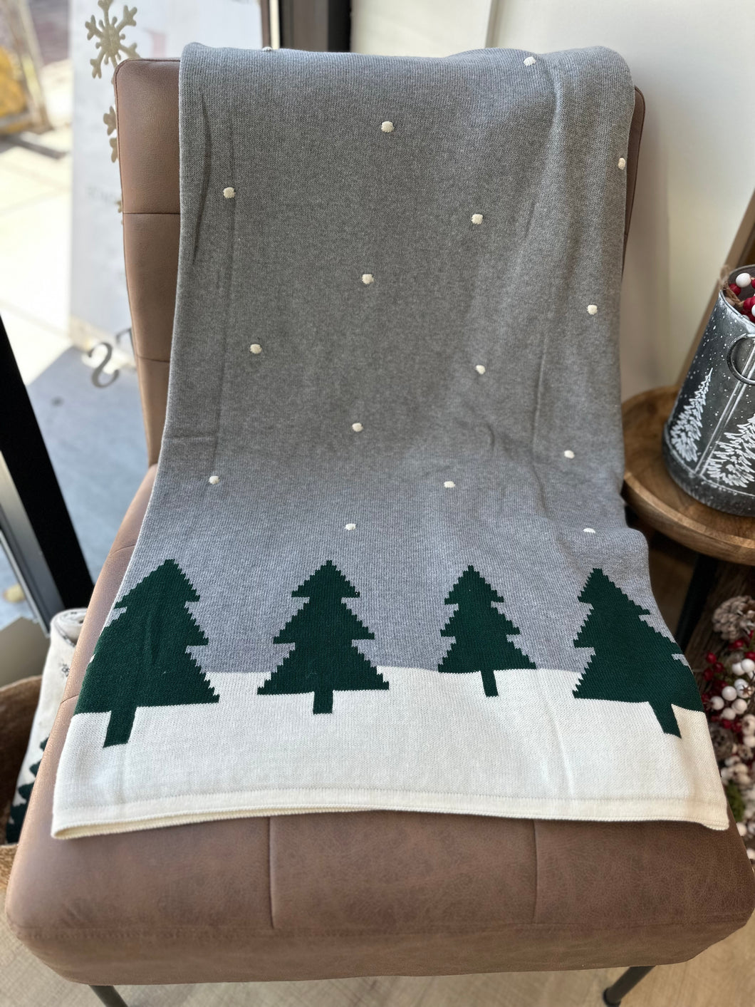 Grey Christmas throw blanket (50X60) with dark green pines and a snowy background. 