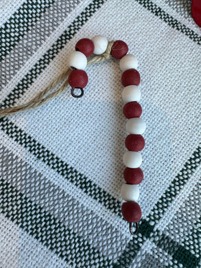 Wooden bead candy cane ornament with jute hanging. 