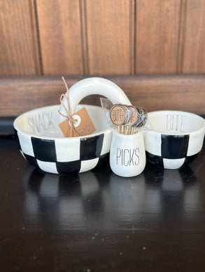 Appetizer dish by Mud Pie.  It is black and white checkered with 2 bowls (one bigger than the other) connected by a handle in the center.  One bowl says 