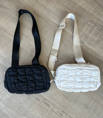 Quilted belt bag in black and cream.  Adjustable straps. 
