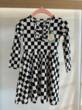 Load image into Gallery viewer, Black and white checkered tutu dress on a hanger. 
