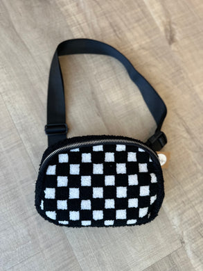 Soft checkered belt bag with adjustable black strap.  