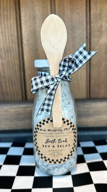 Rev & Relax Bath Soak packaged in a glass milk bottle to celebrate the Indy 500.  Comes with a small wooden spoon attached by a black and white checkered ribbon.  All natural theraputic bath soak. 