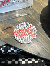 Load image into Gallery viewer, Stone coaster for your car with a red race car in center, a white background, and &quot;Is it May yet?&quot; in black and grey checkered.
