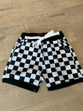 Black and white checkered shorts for baby.  Black outline on legs and waist.  White drawstring. Cotton/spandex blend. 