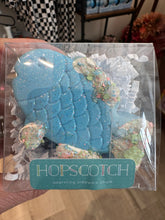 Load image into Gallery viewer, Sidewalk chalk in the shape of a blue fish.  Has &quot;sprinkles&quot; and &quot;icing&quot; on fins.  Packaged in clear plastic container. 
