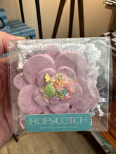 Load image into Gallery viewer, Sidewalk chalk in the shape of a purple flower with &quot;icing&quot; and &quot;sprinkles&quot;. Packaged in a clear plastic container.  By Hopscotch. 
