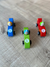Load image into Gallery viewer, Top view of wooden race cars.  Has the number 1 in a white circle painted on front. 
