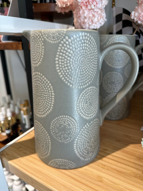 Ceramic grey pitcher with cream circle patter all over.  