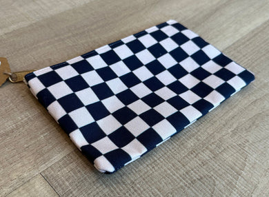 Black and cream checkered pouch with gold zipper.  