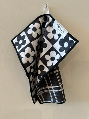 Reversible black and white washcloth.  Floral pattern on one side and box pattern on the other. 