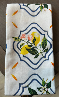 White tea towel with a lemon plant inside framed navy blue design.  Orange accents scattered on towel. 