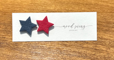 Clay stud star shaped earrings. One is red and the other is navy. 
