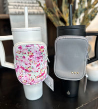 Load image into Gallery viewer, On the move pouch in dark grey or pink florals. 

