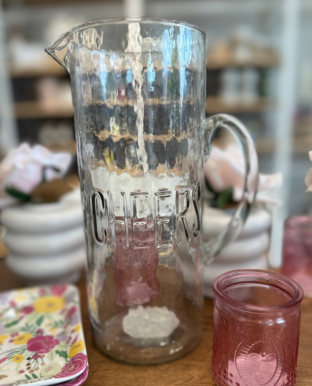 Clear hammered pitcher with CHEERS on front. 