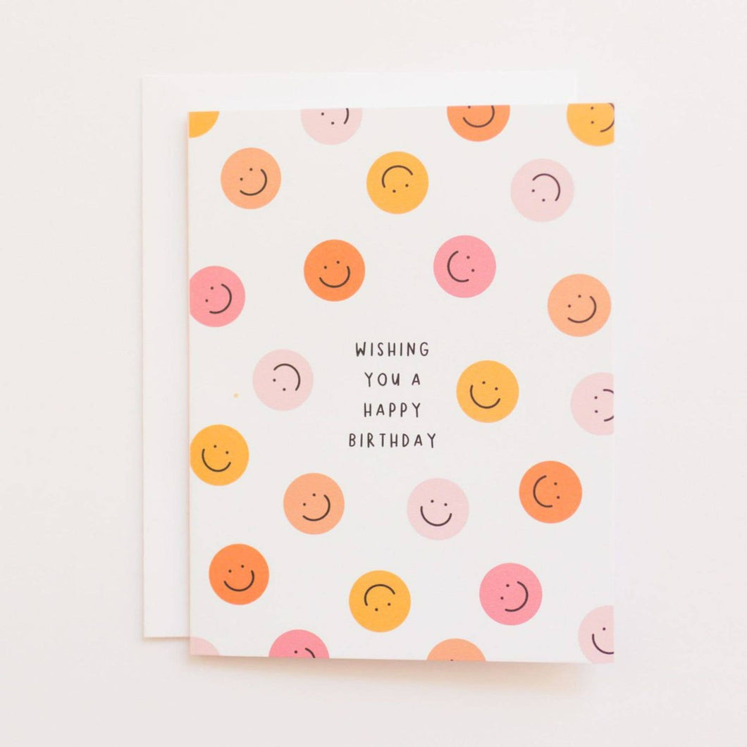 Birthday card--White card with orange and pink smiley faces all over and 