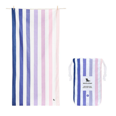 Quick Dry Towel in the color dawn to dusk.  White with various colors of stripes all over ranging from light pink to purple to dark blue.  Also shown is pouch with same design. 