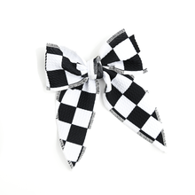 Load image into Gallery viewer, Black and white checkered hair bow with alligator clip in back. 
