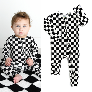 Shows baby wearing checkered long sleeve onesie with zipper on a checkered blanket.  Also shows the onesie by itself.  