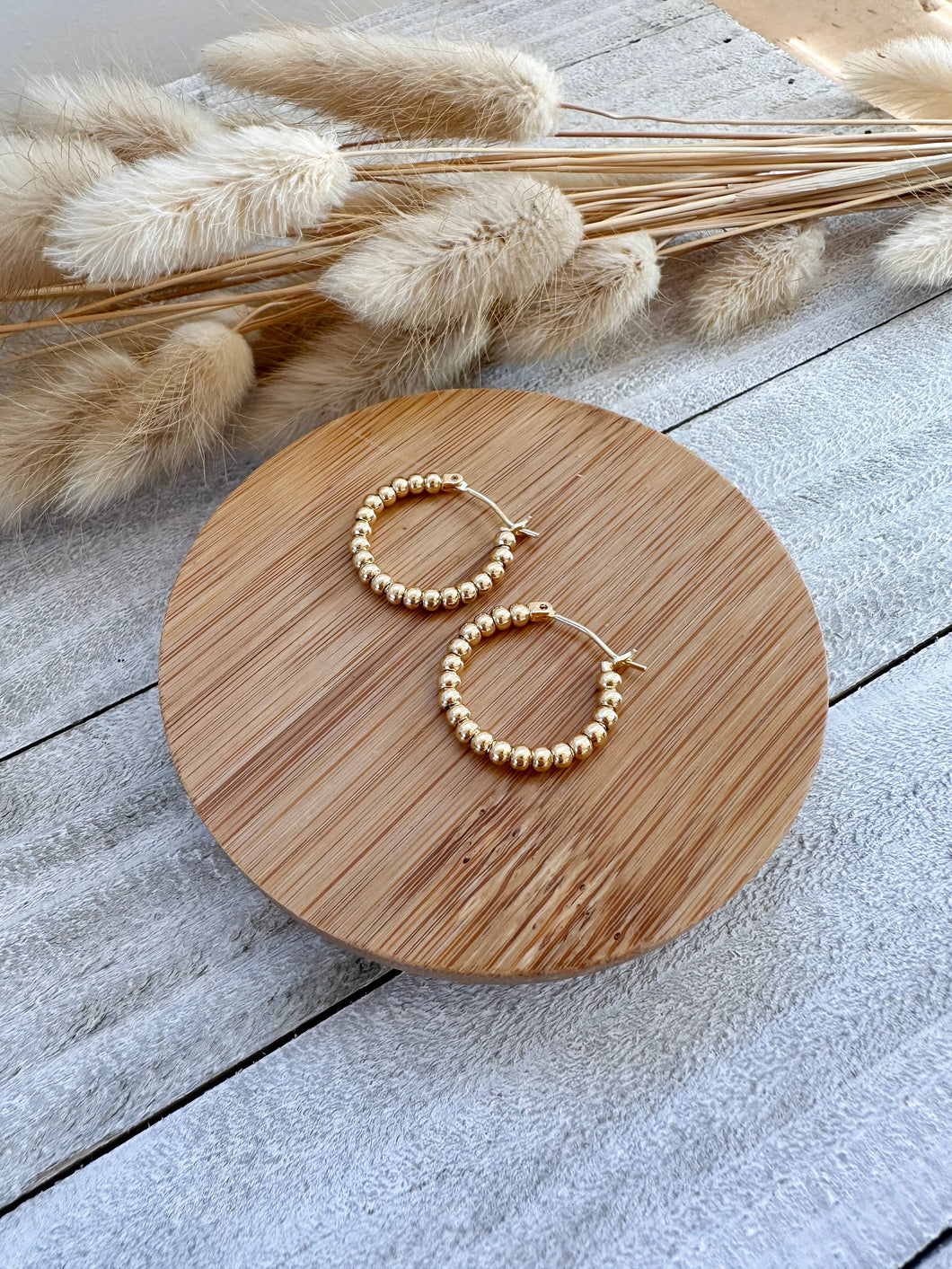 Eye-catching Gold Plated Bauble Hoops: Textured design adds modern flair to classic hoop earrings. Shop now for timeless elegance!