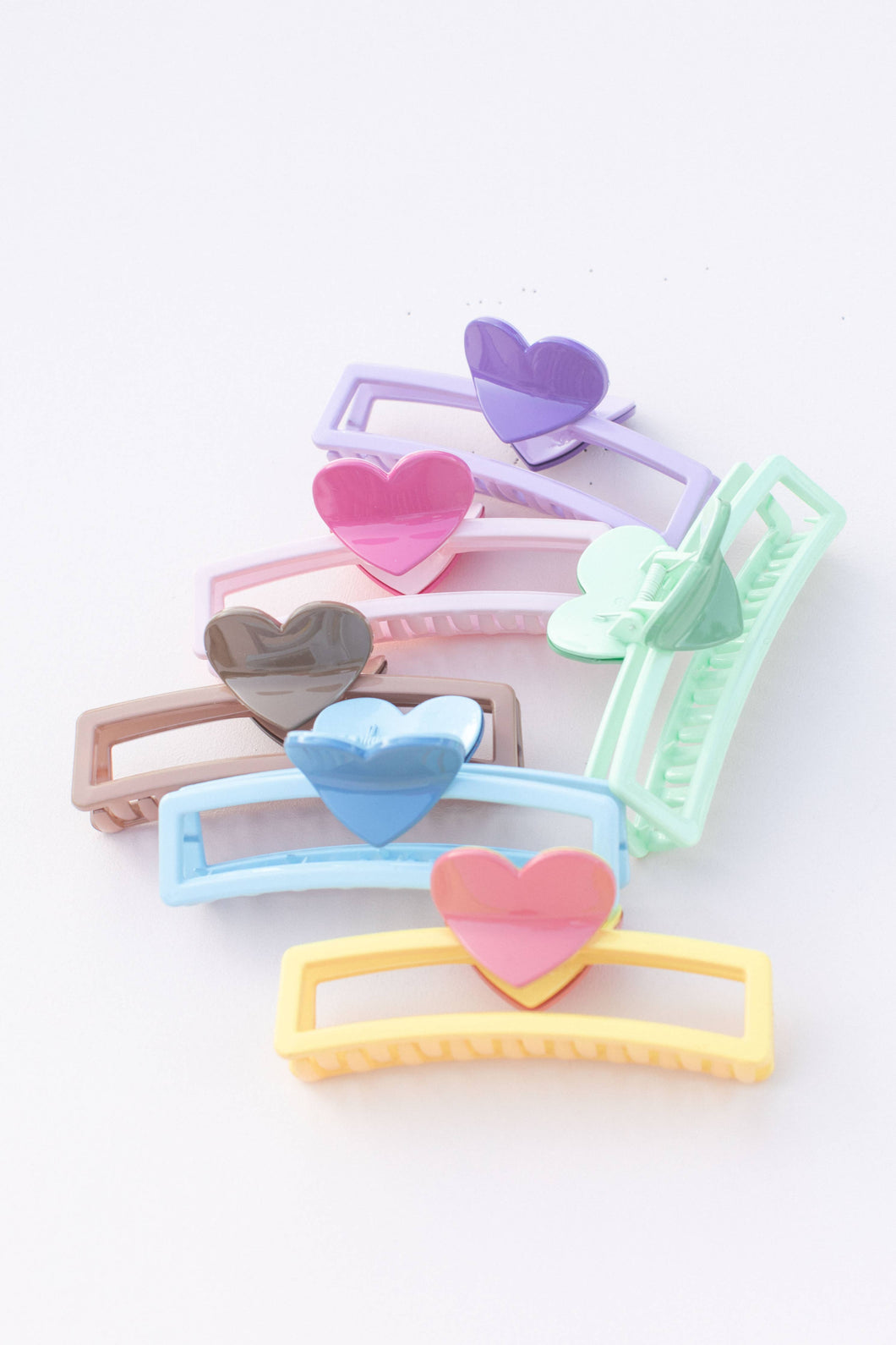 5 inch hair claw clips, in strawberry and chocolate pastel colors with a heart for the handle that opens and closes the clip. 