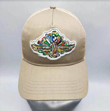 IMS trucker hat in tan with Wing and Wheel logo on front, front few