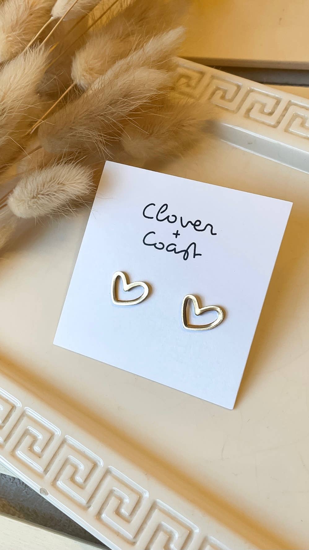 Delicate gold heart stud earrings with open design, perfect for adding a touch of romance to any outfit. #GoldEarrings #HeartJewelry #EverydayLove