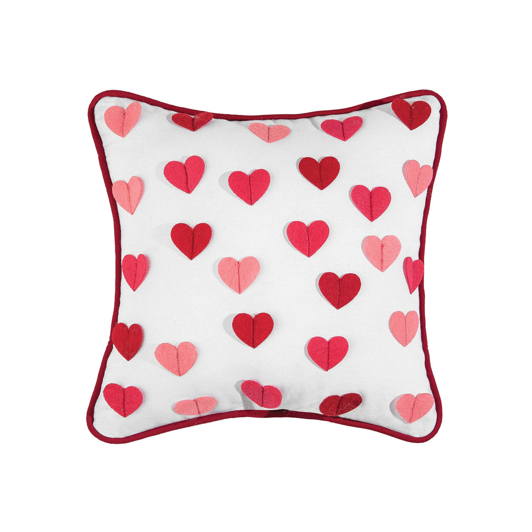Small square white throw pillow with different shades of pink hearts sewn on.  Perfect to add to your Valentine's Day decor. 