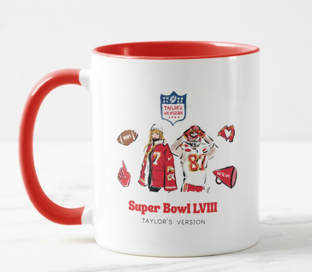 White Taylor and Travis Super Bowl ceramic, 15oz mug with red handle and red interior.  Mug has a drawing of Taylor and Travis with 