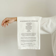 Load image into Gallery viewer, White tea towel with gingerbread cookie recipe in black printed on front
