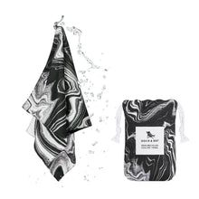 Load image into Gallery viewer, Dock &amp; Bay Quick Cooling Gym Towel in the color &quot;Space Odyssey&quot; which is black, white, and grey swirled all over.  Comes with a pouch to carry it in that is the same pattern. 
