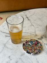 Load image into Gallery viewer, Indy 500 stone coaster, with glass sitting next to it for size comparison
